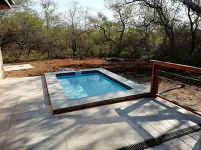 a swimming pool on top of a patio at Cats Corner in Marloth Park