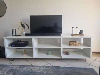 a white entertainment center with a television on it at The cozy 1 bedroom apartment in Midrand