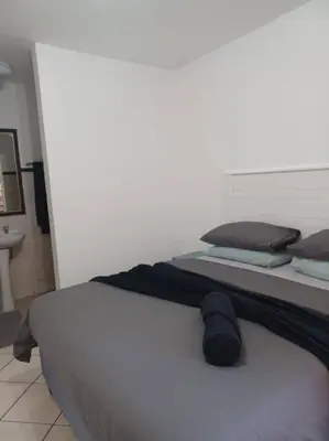 a large white bed in a room at The cozy 1 bedroom apartment in Midrand