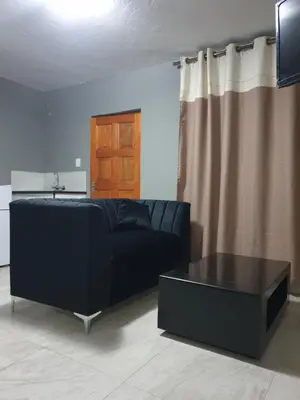a living room with a couch and a coffee table at Platinum Guesthouse Kempton park in Kempton Park