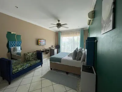 a bedroom with a bed and a chair in it at The Yacht House in Hartbeespoort