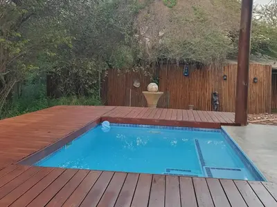 a small swimming pool on a wooden deck at Kanimambo Chalet in Marloth Park
