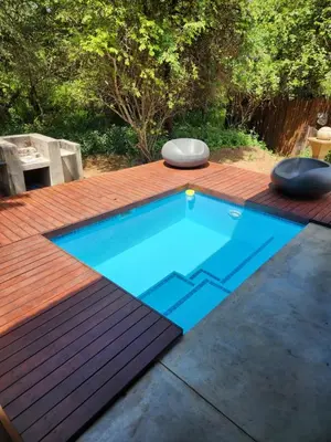 a small swimming pool on a wooden deck at Kanimambo Chalet in Marloth Park
