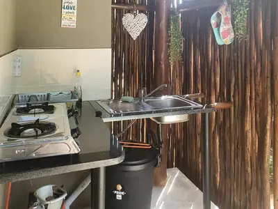 a kitchen with a sink and a stove at Kanimambo Chalet in Marloth Park