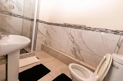 a bathroom with a toilet and a sink at Mandulia Guest House in Nelspruit