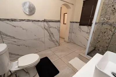 a bathroom with a toilet and a shower at Mandulia Guest House in Nelspruit