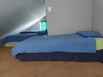 two beds with blue and yellow sheets in a room at Pendleberry Holiday Resort - Unit 40 in Bela-Bela