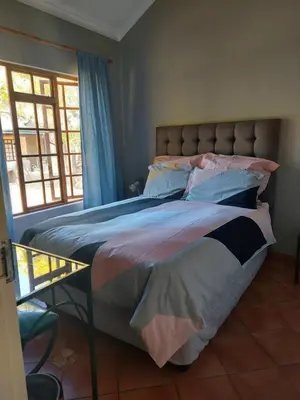 a large bed in a bedroom with a window at Pendleberry Holiday Resort - Unit 40 in Bela-Bela