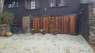 a building with a wooden gate and a patio at Julie's B&B in White River