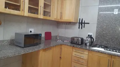 a kitchen with a counter top with a microwave at Julie's B&B in White River
