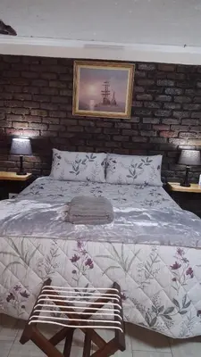 a bedroom with a large bed and two lamps at Julie's B&B in White River