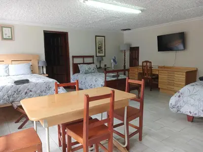 a bedroom with a table and a bed and a dining room at Julie's B&B in White River