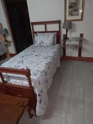 a bedroom with a large bed with a wooden frame at Julie's B&B in White River