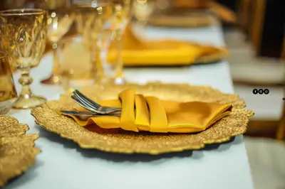 a gold plate with a fork and a yellow napkin at Menlyn Mews Guesthouse in Pretoria