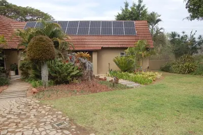 a house with solar panels on the roof at Nita's Air Bed & Breakfast & self catering in Crocodile Valley Estates