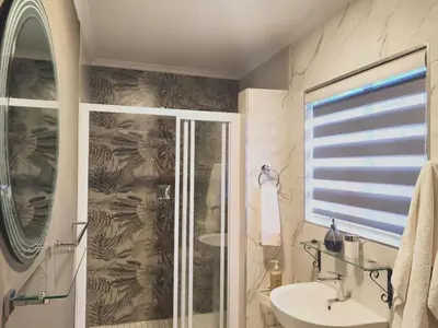 a bathroom with a shower and a sink at Homes of Ace Gold in Pretoria