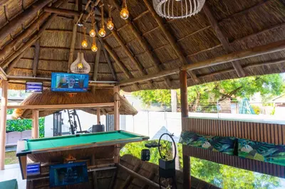a ping pong table in a pavilion with a pool table at Homes of Ace Gold in Pretoria