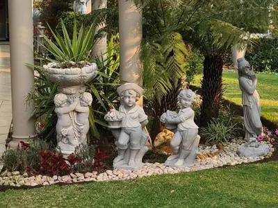 a group of statues of children in a garden at Sunrise Serenity Guest House in Lydenburg