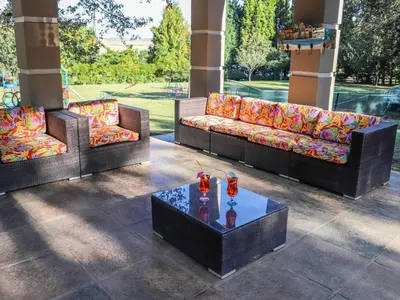 three couches and a table with drinks on it at Sunrise Serenity Guest House in Lydenburg