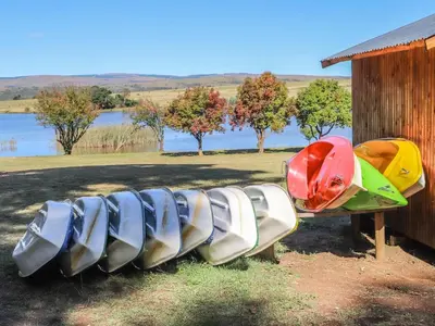 a row of boats lined up next to a building at Sunrise Serenity Guest House in Lydenburg