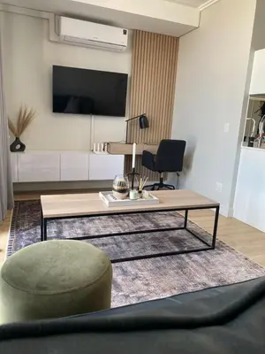 a living room with a coffee table and a chair at Executive Apartment at Ellipse Waterfall in Midrand