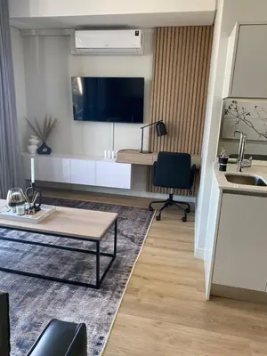 a living room with a table and a sink at Executive Apartment at Ellipse Waterfall in Midrand