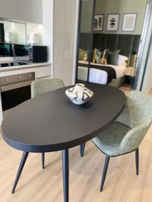 a black table with two chairs and a vase on top at Executive Apartment at Ellipse Waterfall in Midrand