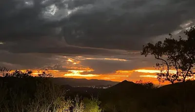 a sunset with dark clouds in the sky at The Hank Maribashoek Adventure Lodge in Mokopane
