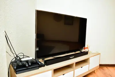 a flat screen tv sitting on a wooden entertainment center at MTH in Nelspruit