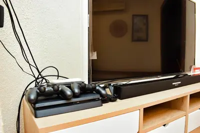 a television on top of a wooden entertainment center at MTH in Nelspruit
