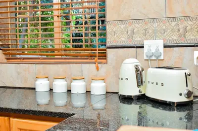 a kitchen counter with a coffee maker and a toaster at MTH in Nelspruit