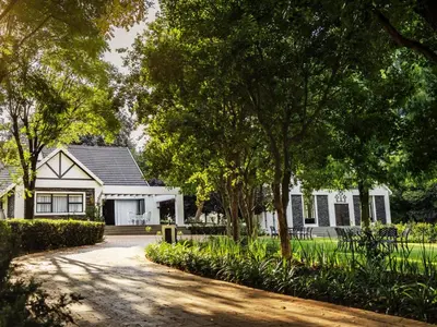 a white house with trees and a driveway at Gracia de Dios in Benoni