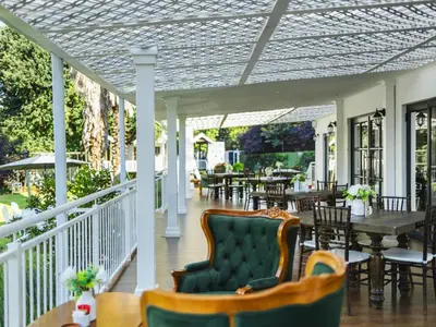a porch with a table and chairs and tables at Gracia de Dios in Benoni