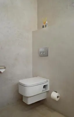a bathroom with a toilet and a roll of toilet paper at Augusta Palms - White Room in Centurion