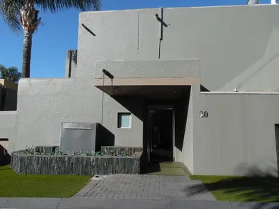 a white building with a ramp leading to a door at Augusta Palms - White Room in Centurion