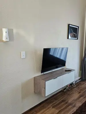a flat screen tv sitting on top of a wall at Pine View Guesthouse Graskop in Graskop
