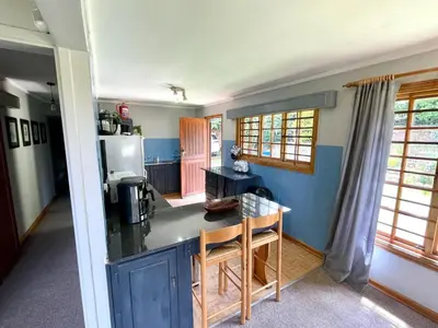 a kitchen with blue walls and a counter top at The Hedge at Dullstroom Cottage in Dullstroom