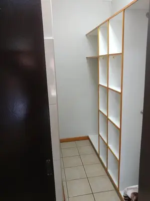 a room with a closet with a door and shelves at Ebeneezer Self-Catering Guesthouse in the Lowveld in Sabie