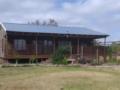 a large wooden house with a metal roof at Mogale Royal Gardens in Polokwane