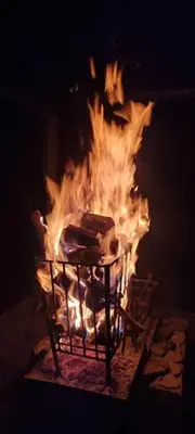 a large fire in a fireplace with flames at Vanross Self Catering Accommodation in Thabazimbi