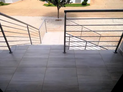 a set of stairs with metal railings on a sidewalk at Thomsons Lodge in Polokwane