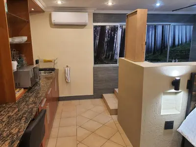 a kitchen with a sink and a counter top at Bikkurim Inn in Nelspruit
