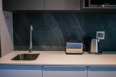 a kitchen counter with a sink and a toaster at 703 Menlyn Maine Residences, The Trilogy in Pretoria