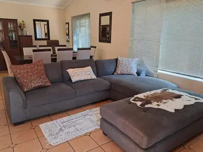 a living room with a couch and a table at Harambi in Nelspruit