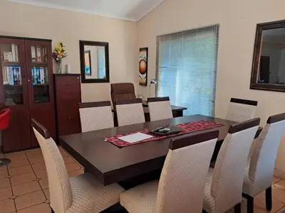 a dining room with a table and chairs at Harambi in Nelspruit