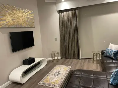 a living room with a couch and a flat screen tv at Menlyn Maine Unit 1421 in Pretoria