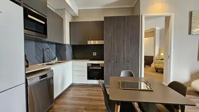 a kitchen with a table and a dining room at Menlyn Maine Unit 1421 in Pretoria