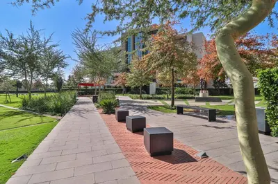 a park with benches and trees and a building at Menlyn Maine Unit 1420 in Pretoria
