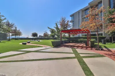 a park with a red structure in front of a building at Menlyn Maine Unit 1420 in Pretoria