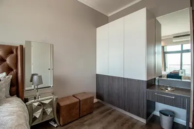 a bedroom with a bed and a large mirror at Menlyn Maine Unit 1420 in Pretoria